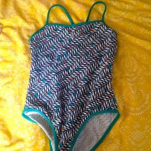Patagonia girls bathing suit in leaf pattern.